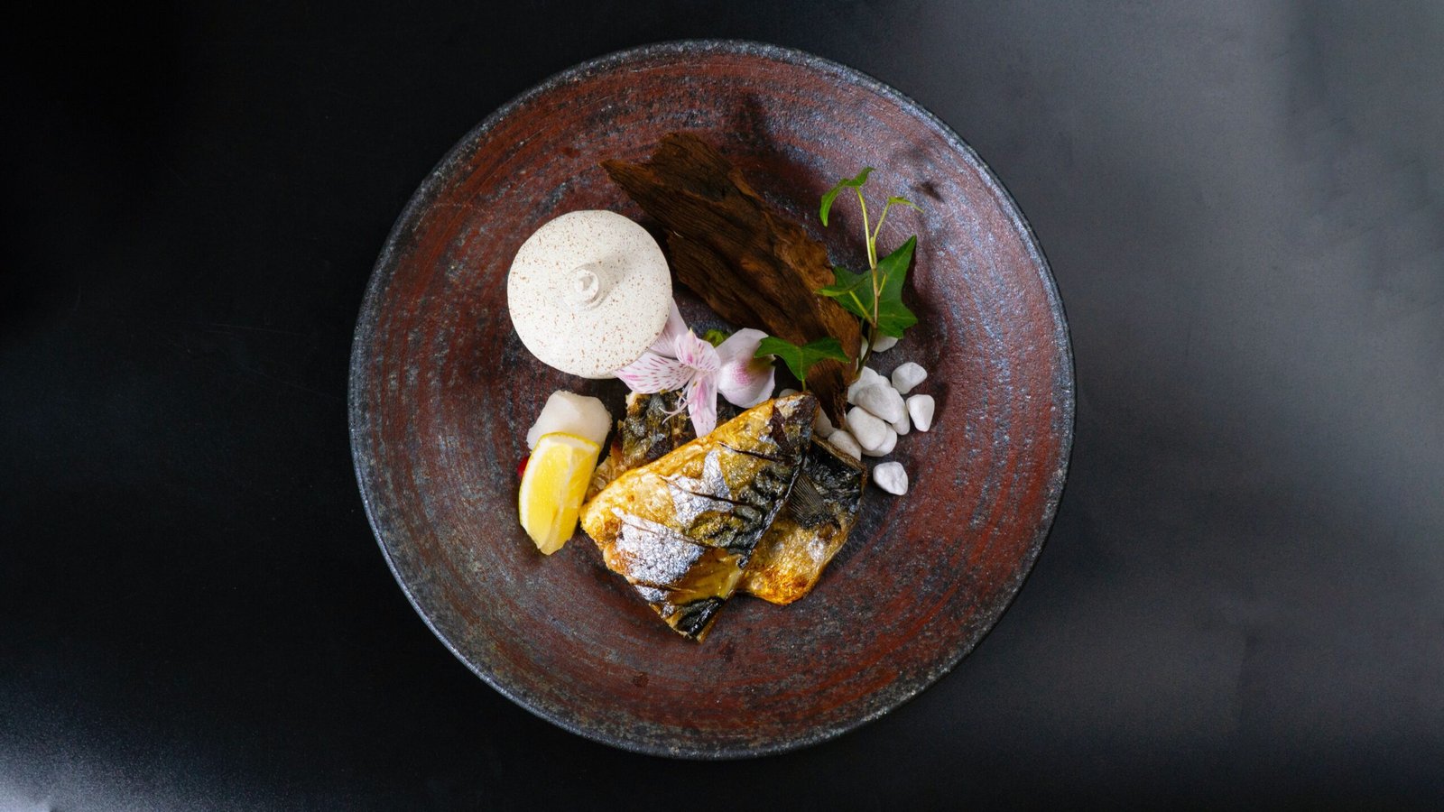 Elegant dish featuring fish and vegetables on a rustic plate, perfect for stylish dining scenes.