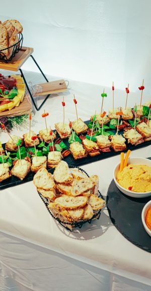 Delicious assortment of sandwiches and dips on a buffet table, perfect for events.